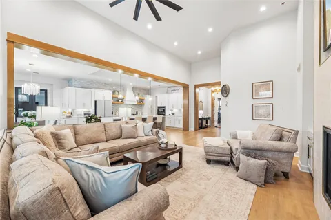 a kitchen with stainless steel appliances kitchen island granite countertop a table chairs sink and cabinets
