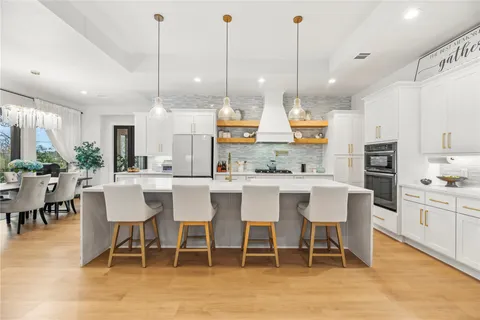a kitchen with a table chairs and a refrigerator