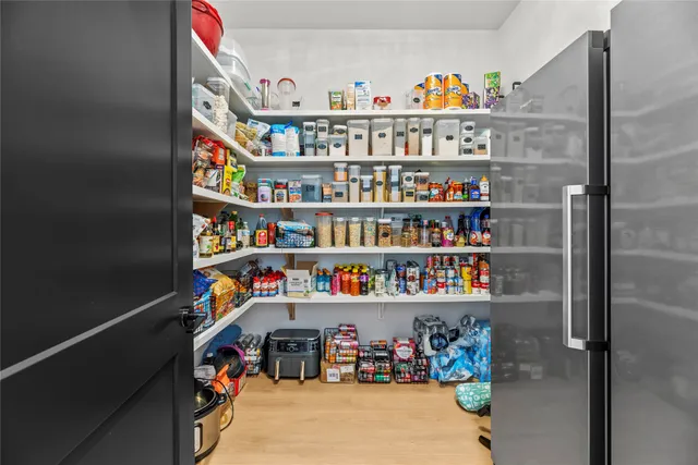 a view of an front door and cabinet with hallway