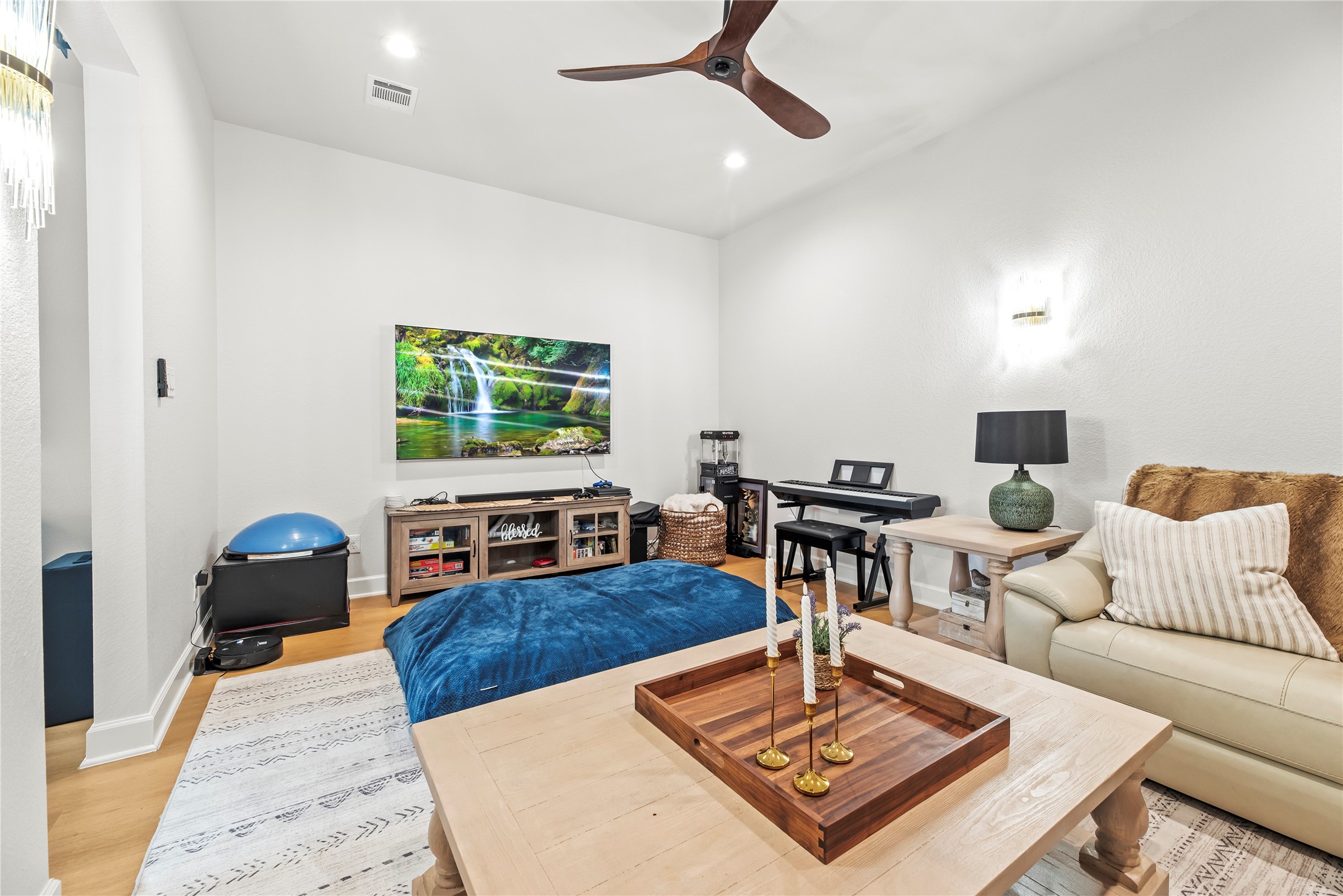4218 Wooded Isle Way Fulshear, TX 77441 - Photo 23 of 50 a living room with furniture a rug and a flat screen tv