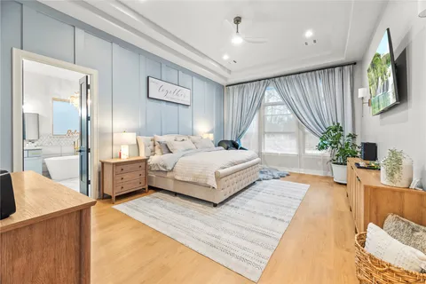 a spacious bathroom with a double vanity sink mirror and bathtub