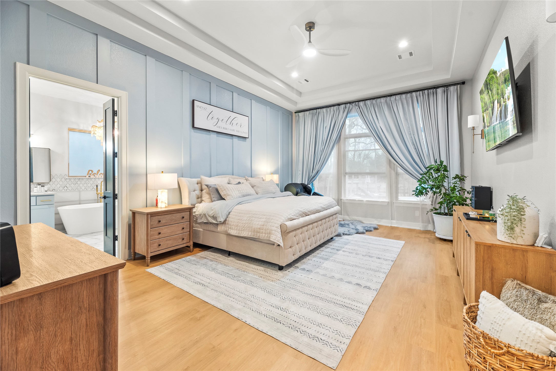 4218 Wooded Isle Way Fulshear, TX 77441 - Photo 24 of 50 a spacious bedroom with a large bed a flat screen tv and a couch