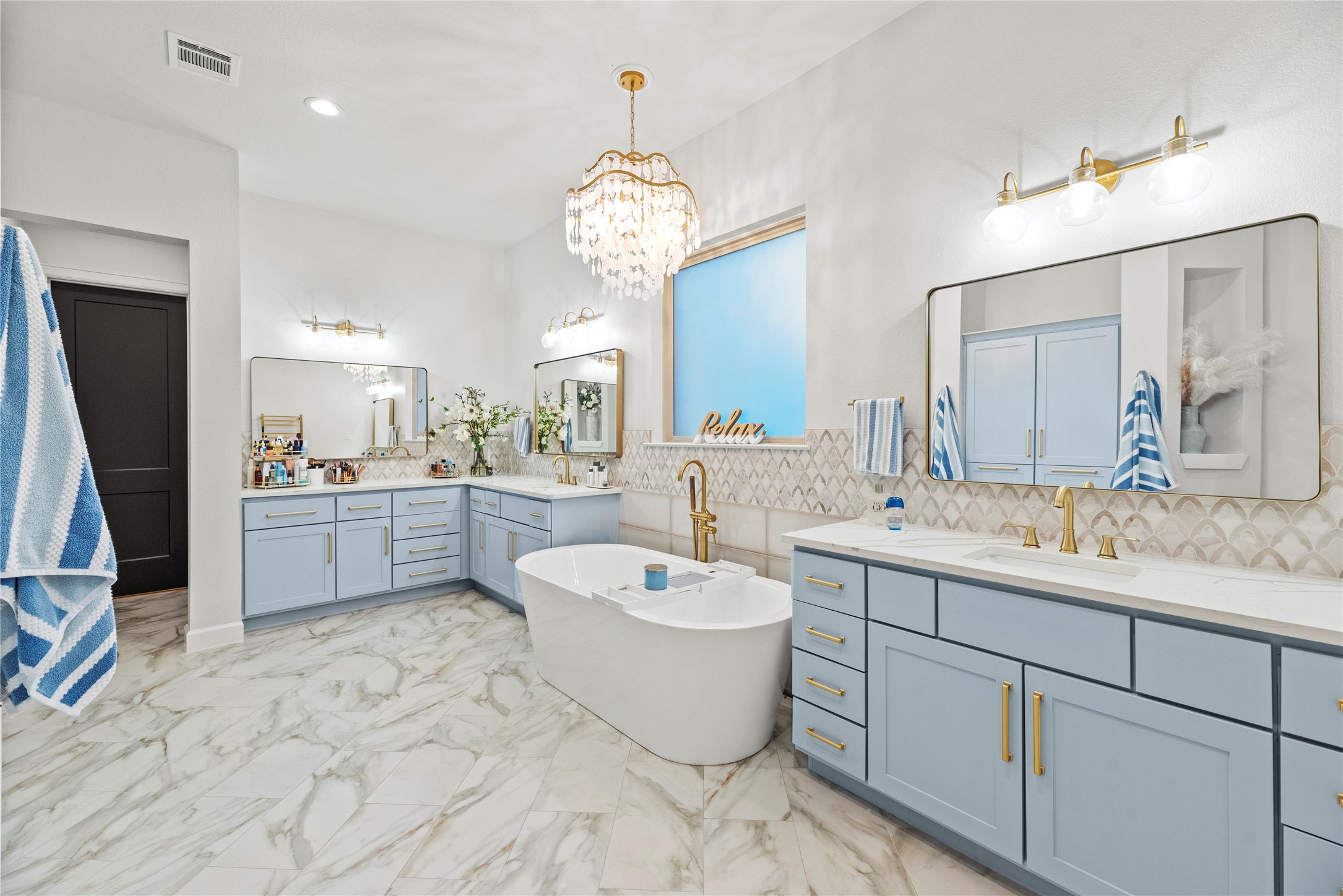 4218 Wooded Isle Way Fulshear, TX 77441 - Photo 27 of 50 a large bathroom with a double vanity sink a mirror and a bathtub