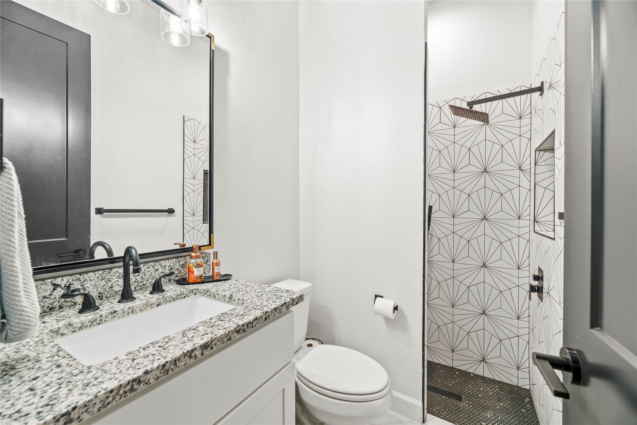 4218 Wooded Isle Way Fulshear, TX 77441 - Photo 32 of 50 a bathroom with a granite countertop sink toilet and shower