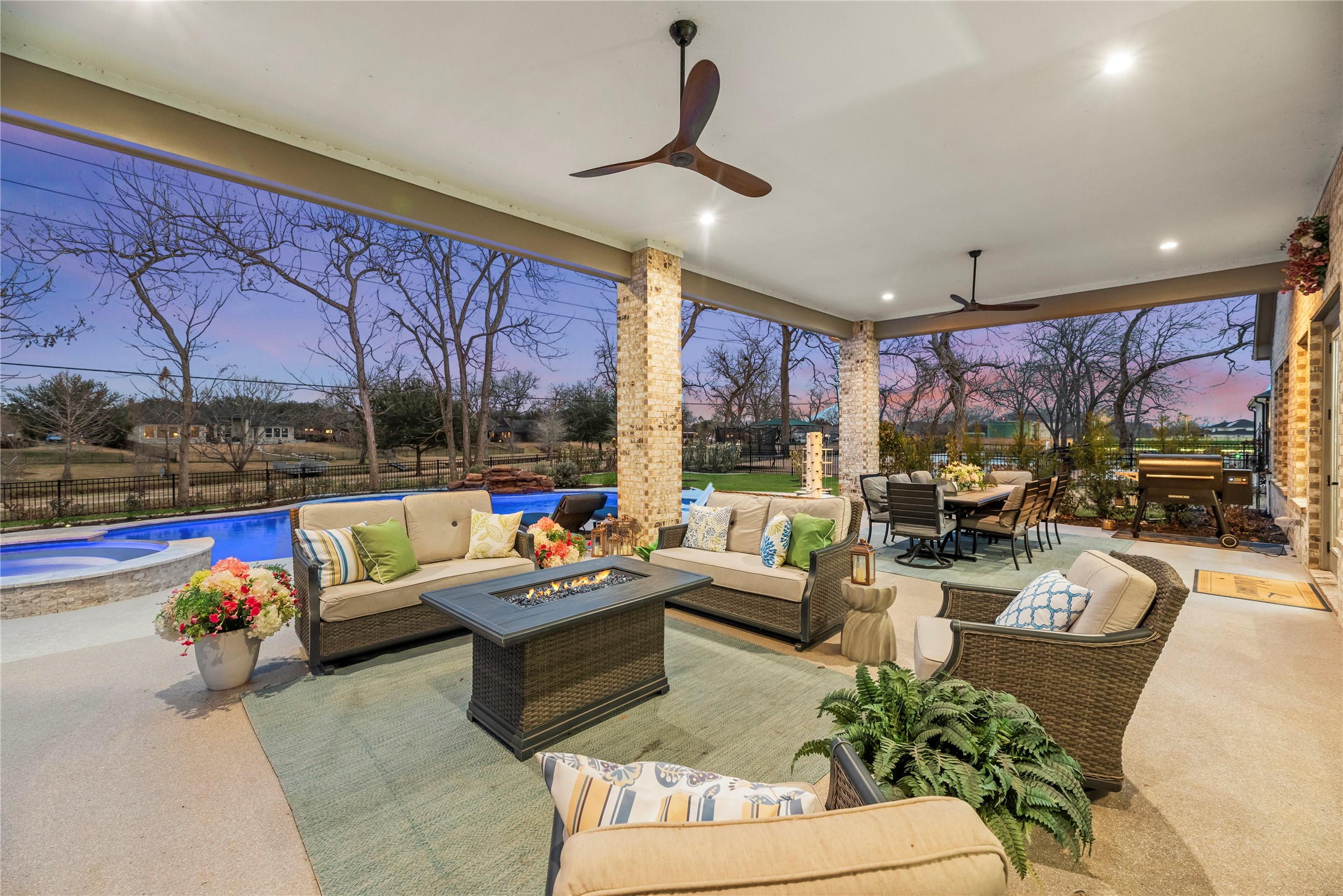 4218 Wooded Isle Way Fulshear, TX 77441 - Photo 37 of 50 a living room with patio furniture and a chandelier