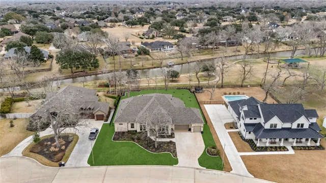 an aerial view of a house with a swimming pool