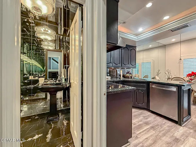 a kitchen with kitchen island a sink appliances and cabinets