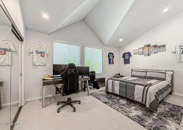 a bed room with furniture and a large window