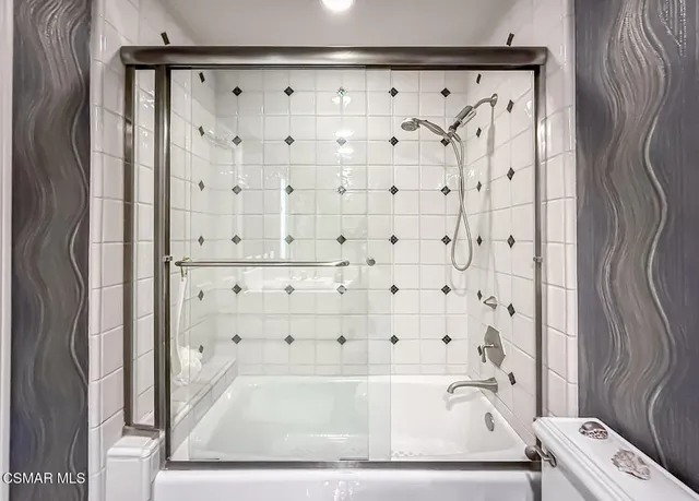 a view of a patio with chairs and potted plants
