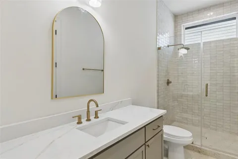 a bathroom with a sink toilet and shower