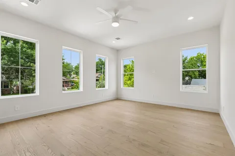 an empty room with windows and closet
