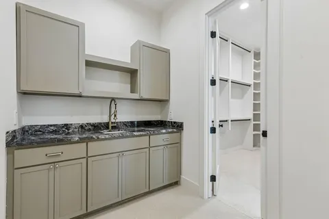 a kitchen with white cabinets and white appliances