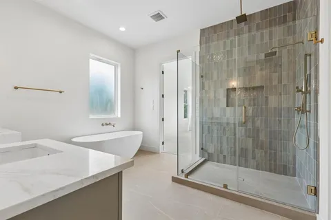 a bathroom with a shower and a sink