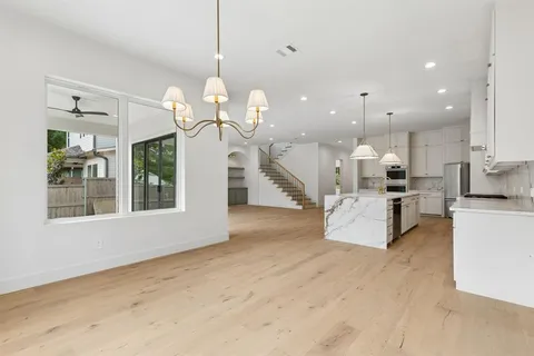 a view of a kitchen with cabinets and wooden floor