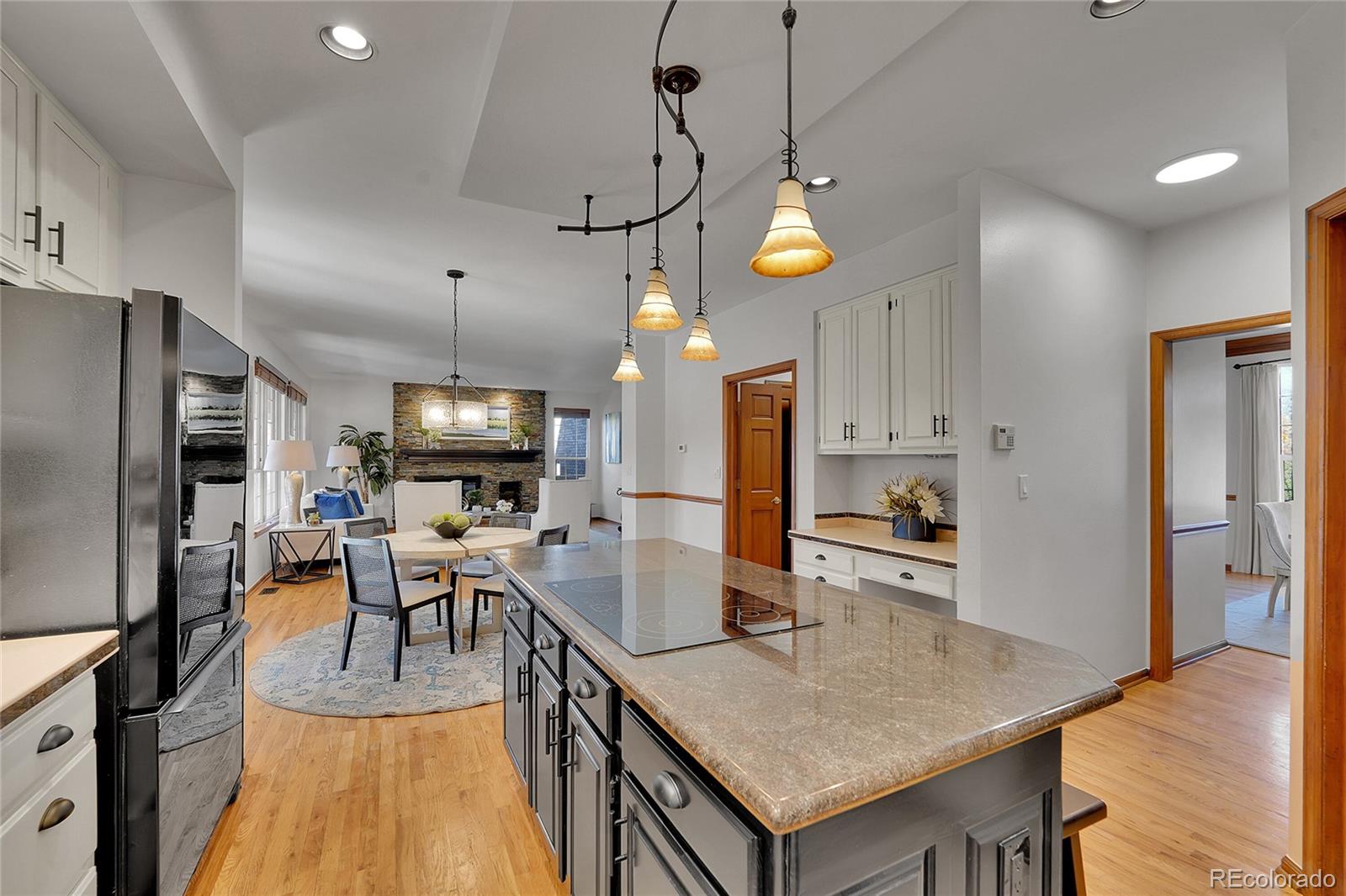2226 Thistle Ridge Circle Highlands Ranch, CO 80126 - Photo 11 of 49 a large kitchen with a table and chairs