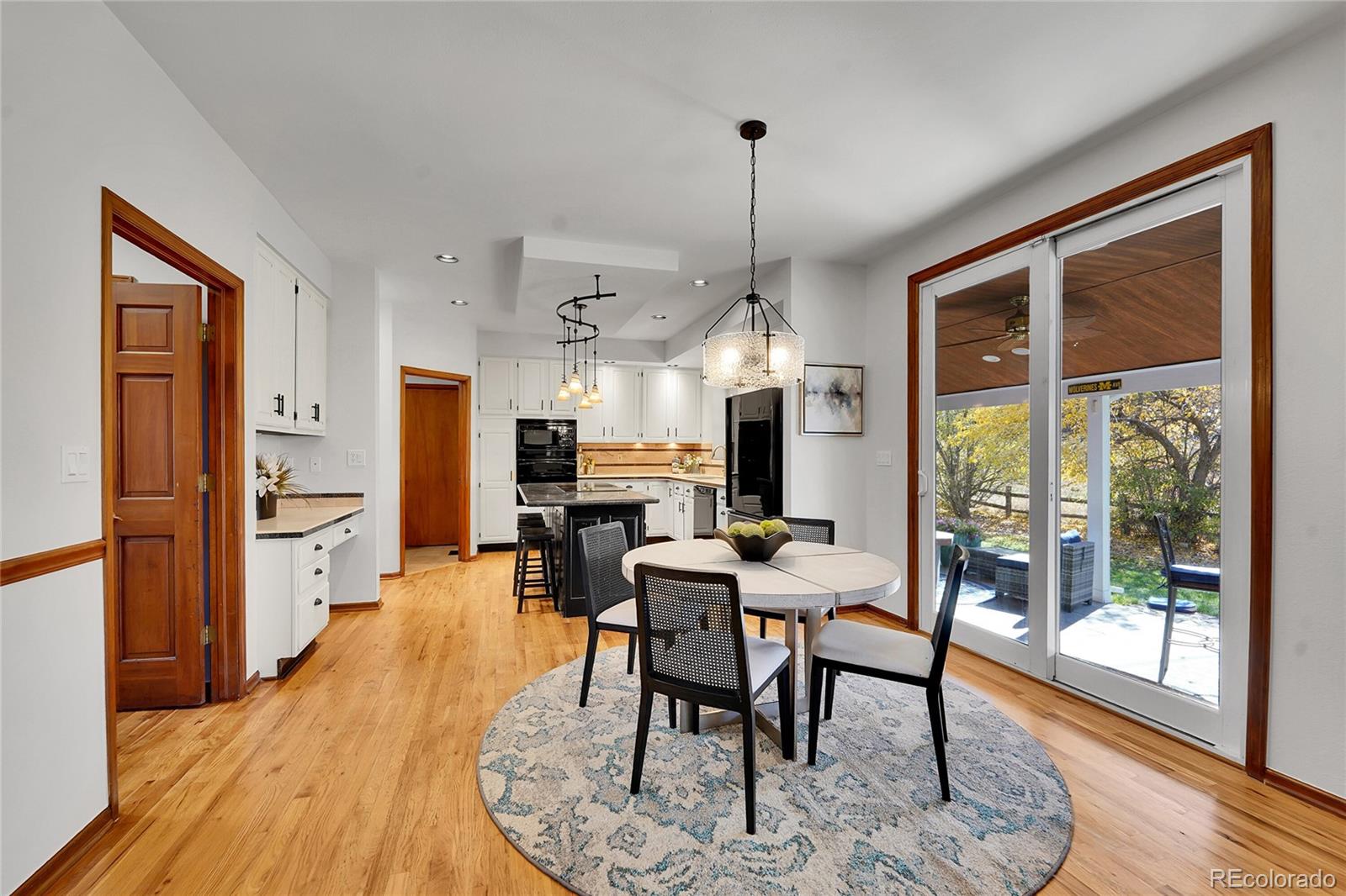 2226 Thistle Ridge Circle Highlands Ranch, CO 80126 - Photo 12 of 49 a view of a dining room with furniture window and wooden floor
