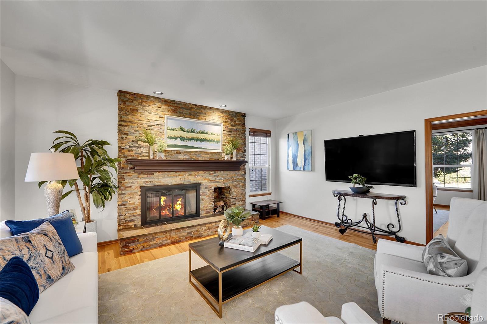 2226 Thistle Ridge Circle Highlands Ranch, CO 80126 - Photo 15 of 49 a living room with furniture and a flat screen tv