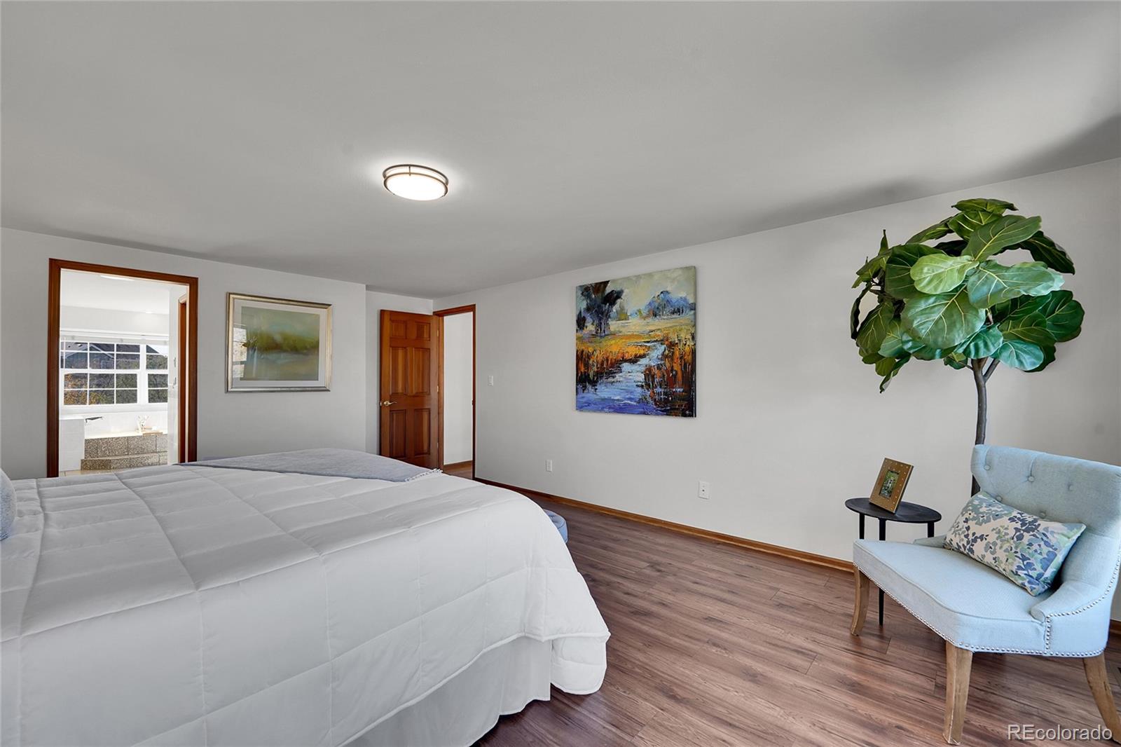 2226 Thistle Ridge Circle Highlands Ranch, CO 80126 - Photo 22 of 49 a bedroom with furniture and a potted plant