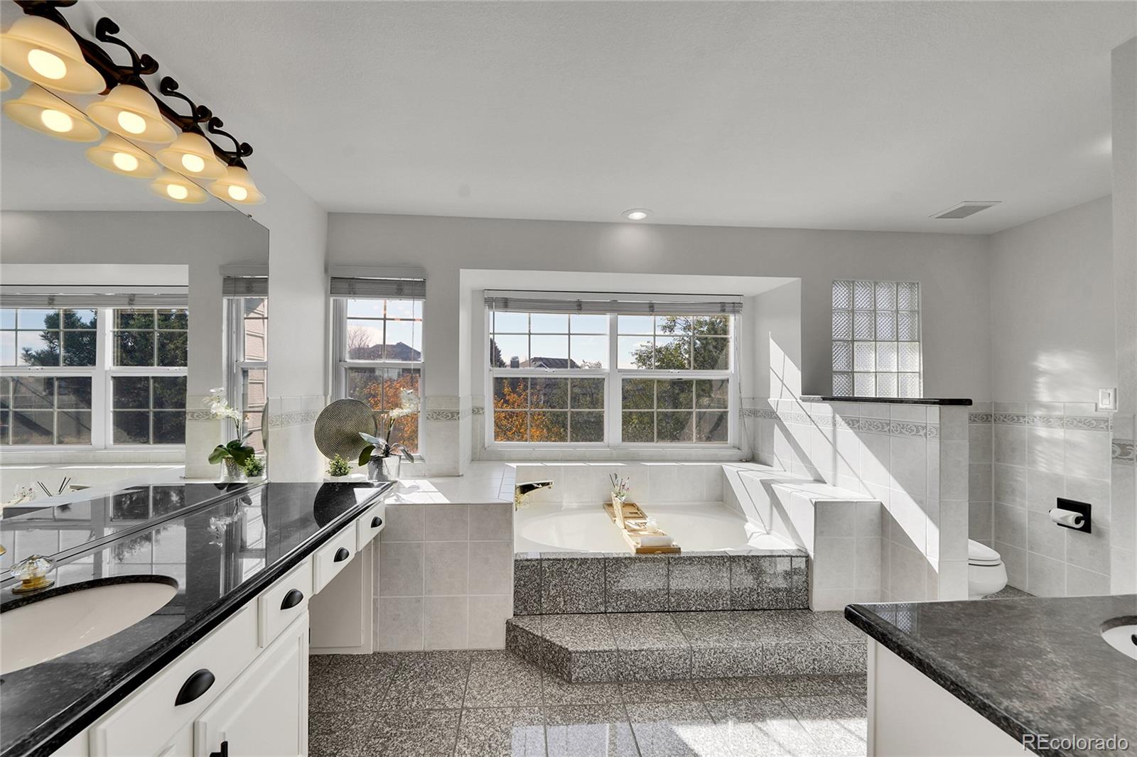 2226 Thistle Ridge Circle Highlands Ranch, CO 80126 - Photo 23 of 49 a large white kitchen with granite countertop a large counter top and sink
