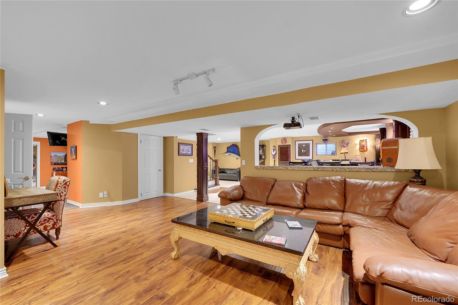 2226 Thistle Ridge Circle Highlands Ranch, CO 80126 - Photo 31 of 49 a living room with furniture and a wooden floor