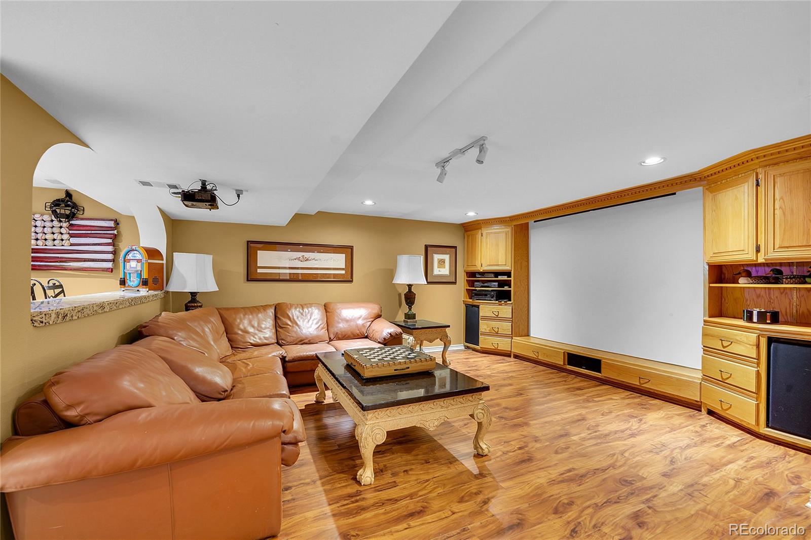 2226 Thistle Ridge Circle Highlands Ranch, CO 80126 - Photo 33 of 49 a living room with furniture and a flat screen tv