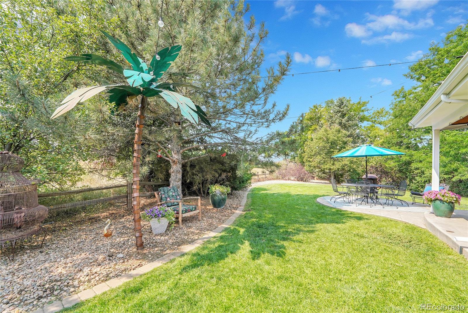 2226 Thistle Ridge Circle Highlands Ranch, CO 80126 - Photo 36 of 49 a view of a patio with a table and chairs under an umbrella