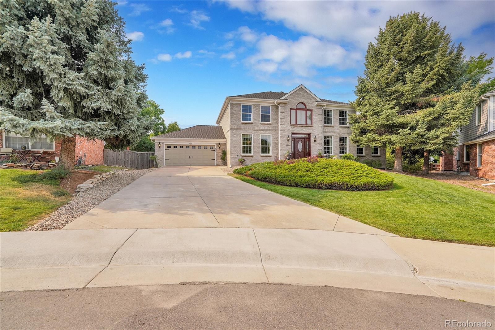 2226 Thistle Ridge Circle Highlands Ranch, CO 80126 - Photo 45 of 49 a view of a white house with a yard
