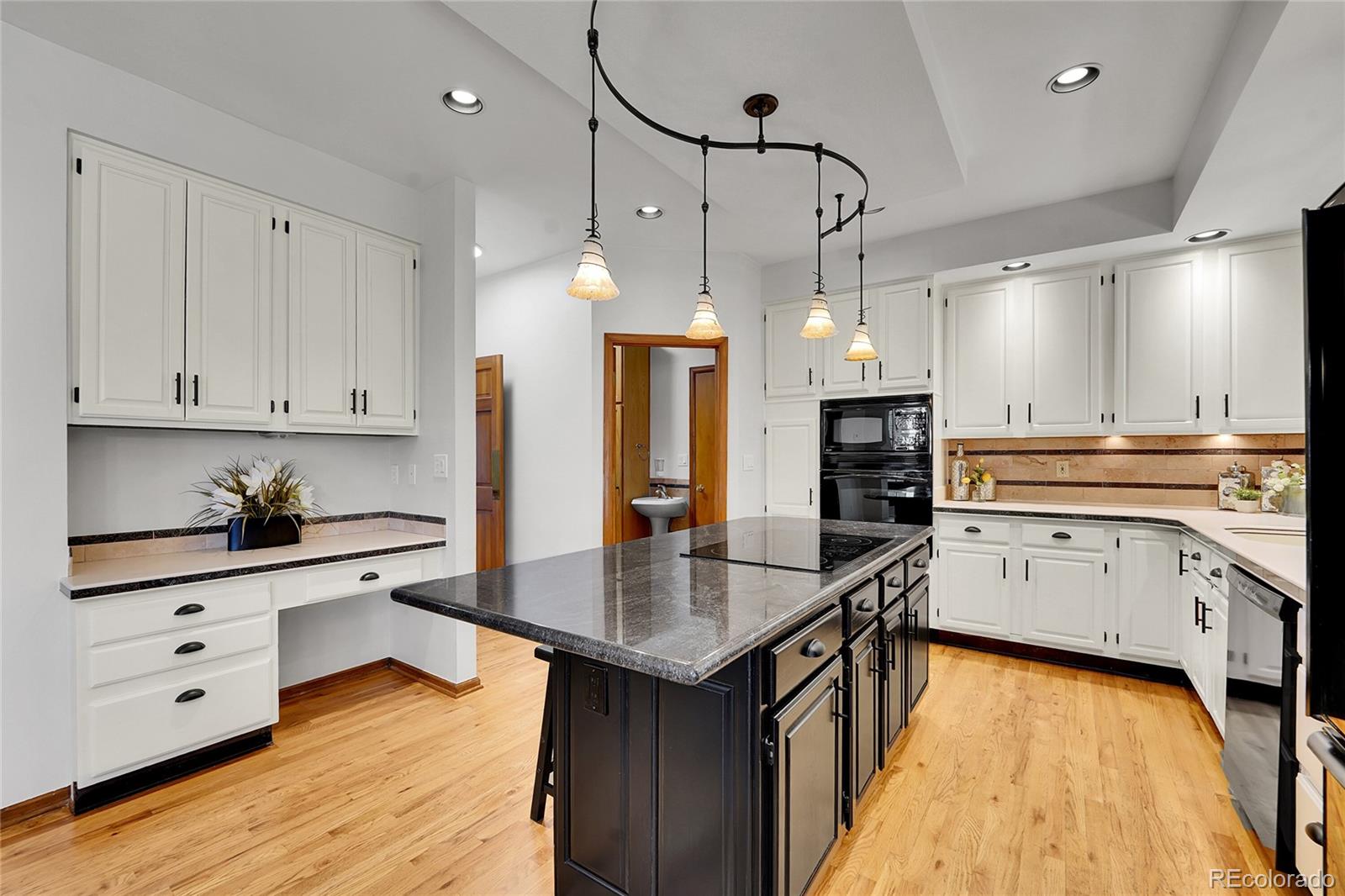 2226 Thistle Ridge Circle Highlands Ranch, CO 80126 - Photo 8 of 49 a kitchen with white cabinets and appliances