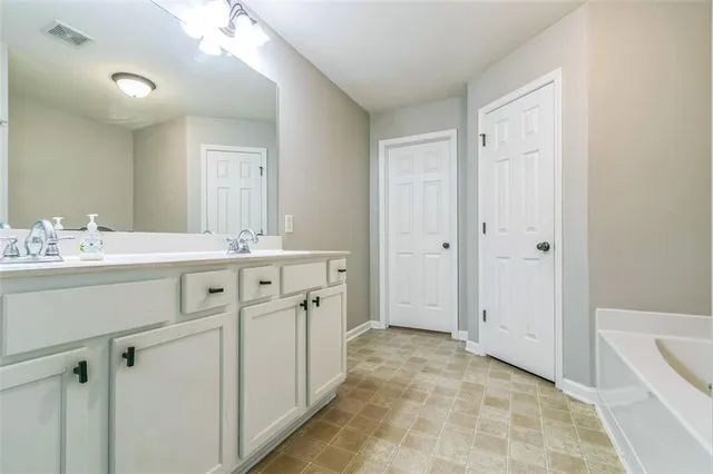 a bathroom with a sink a vanity and a mirror