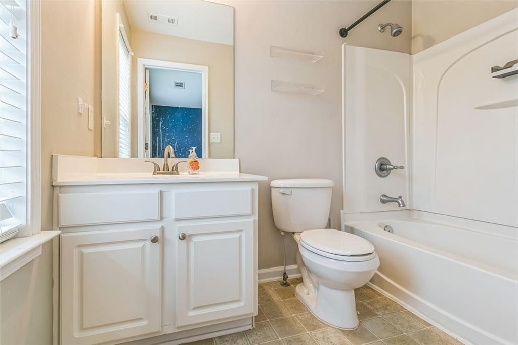 4358 Grove Field Court Northwest Suwanee, GA 30024 - Photo 16 of 17 a bathroom with a sink toilet and shower