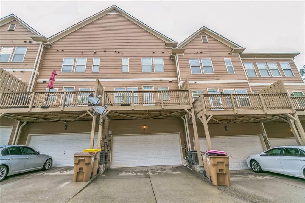 4358 Grove Field Court Northwest Suwanee, GA 30024 - Photo 2 of 17 a front view of a house with parking