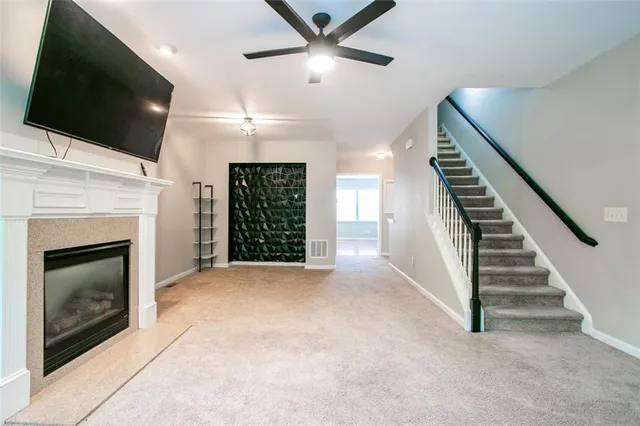 a view of an empty room with fireplace and a window