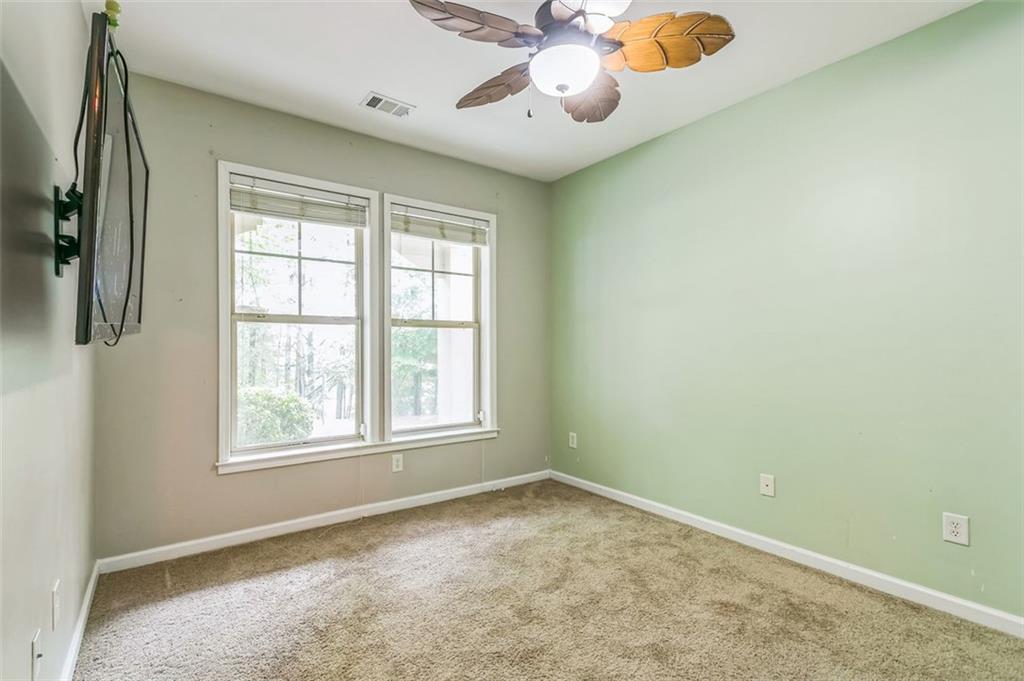 4358 Grove Field Court Northwest Suwanee, GA 30024 - Photo 6 of 17 an empty room with a window