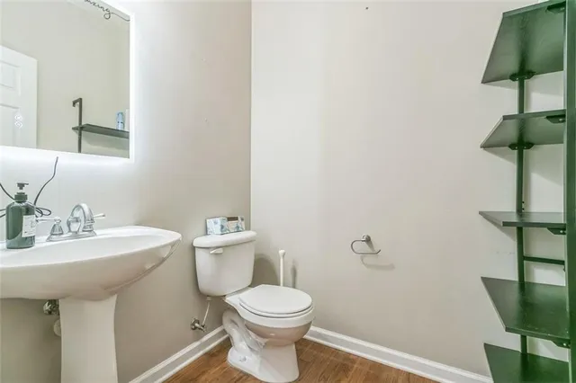 a bathroom with a toilet a sink and a mirror