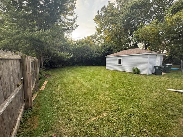 a view of a terrace with wooden floor and fence and a wooden bench