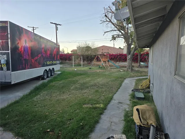 a backyard of a house with table and chairs