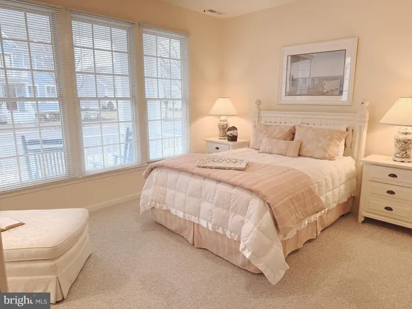 a spacious bedroom with a bed and a couch