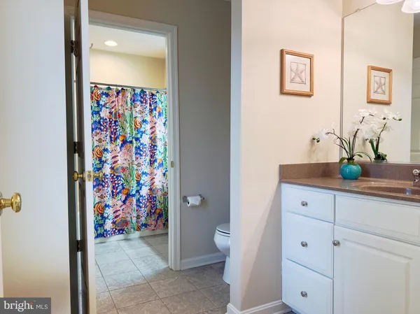 a bathroom with a painting on the wall and a sink