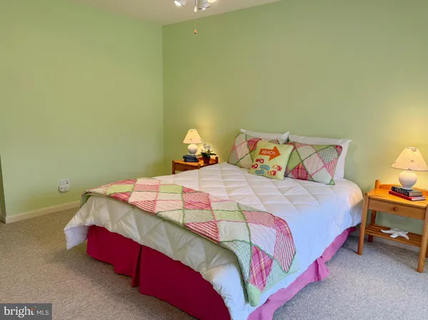 a bedroom with a bed and a lamp