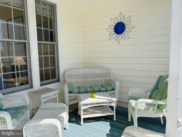 a view of balcony with furniture and umbrella