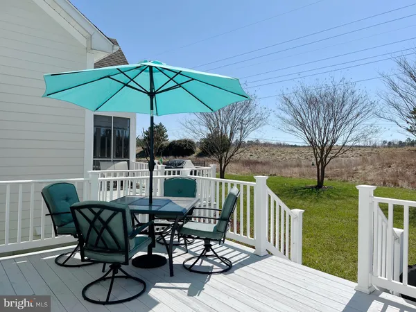 a view of a deck with furniture and a yard
