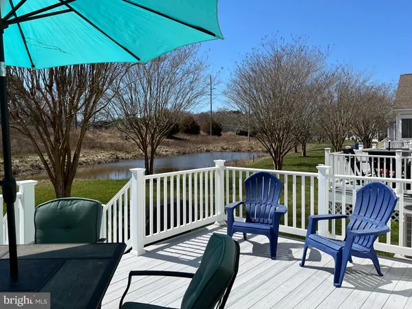 a view of a chairs and table in the river near a lake