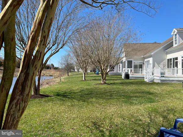 a front view of a house with a yard and potted plants