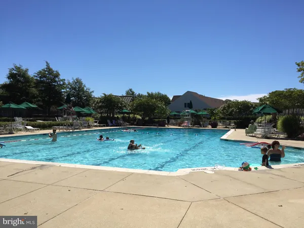 a swimming pool with outdoor seating and yard
