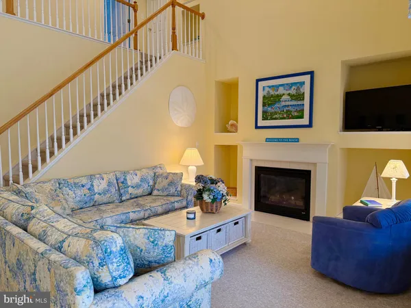 a living room with furniture fireplace and flat screen tv