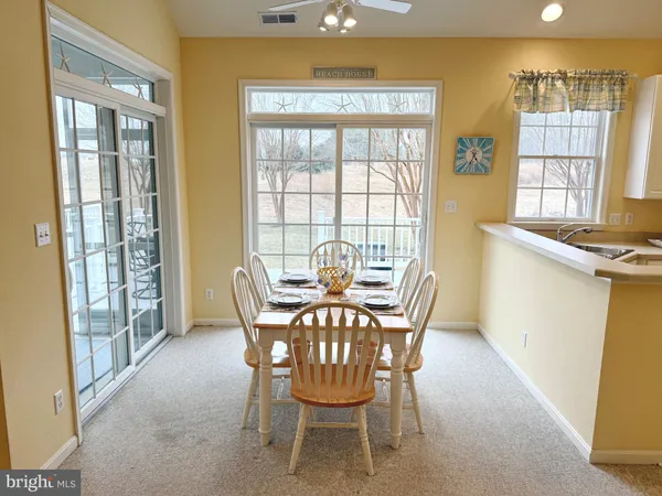 a view of a dining room with furniture and windows