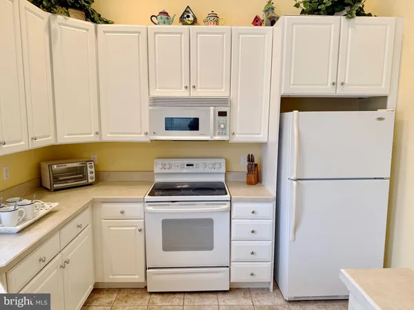 a kitchen with appliances a sink and cabinets