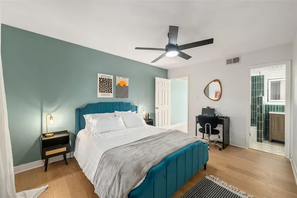 a bedroom with bed and a chandelier