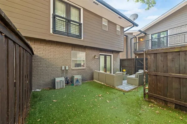 a view of a backyard with table and chairs and wooden fence