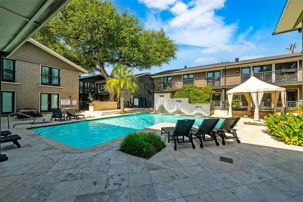 a view of a house with swimming pool and sitting area
